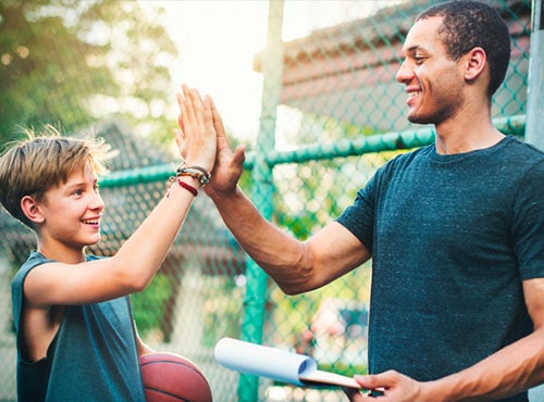 Coach and Player high fiving