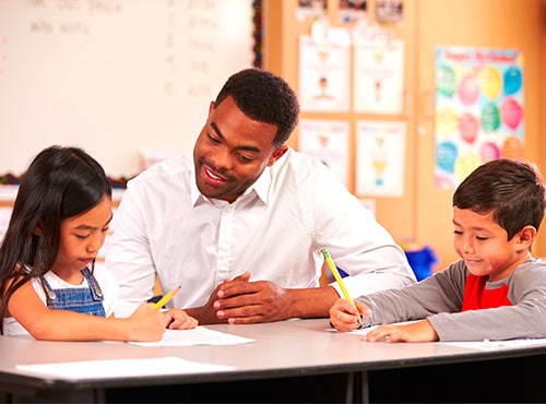 Teacher working with students